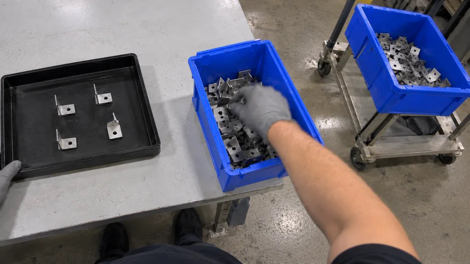 Camera 5, right side, inner: the right hand in the blue bin, the cart behind it