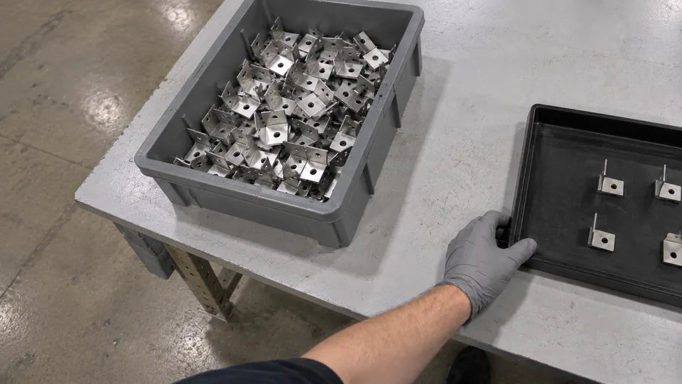 Camera 2, left side, inner: the grey bin and the left hand on the tray
