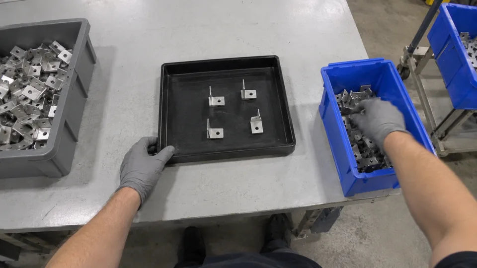 Camera 3, front left: both hands, the tray in front and the bins on either side