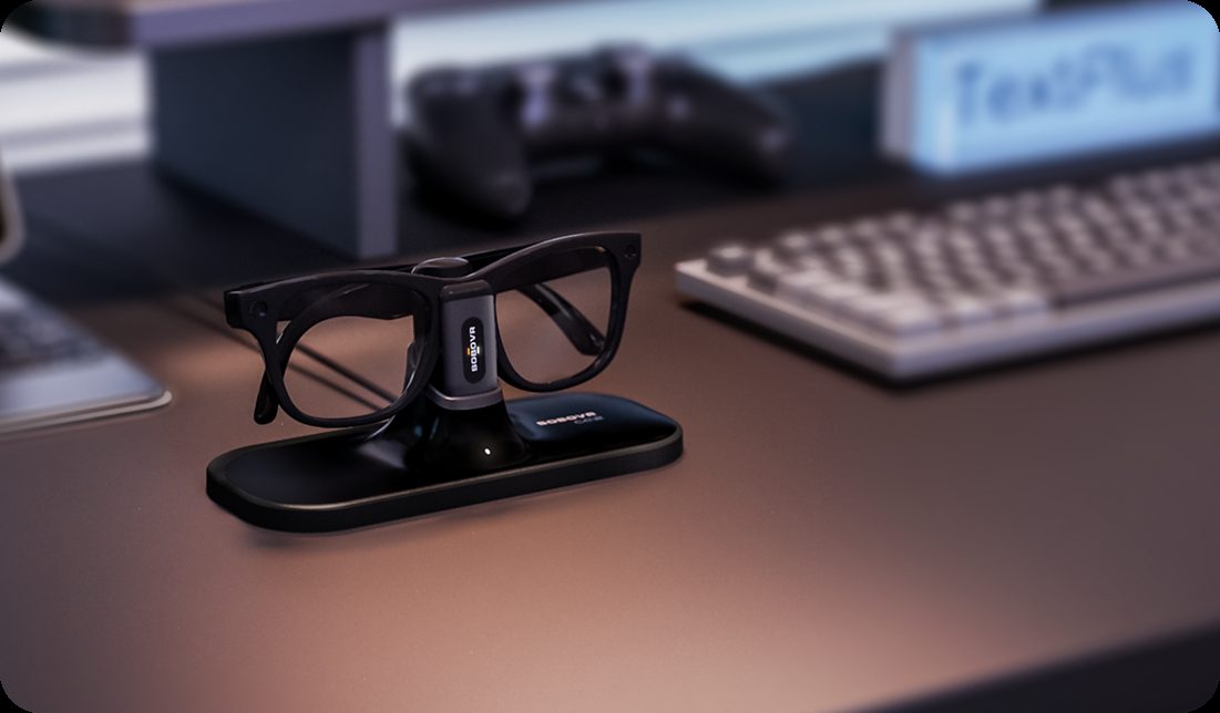 Meta smart glasses charging on a BOBOVR CG2 magnetic dock on a desk